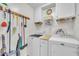 Laundry room with white washer and dryer and ample storage space at 85 Willard Wood Run, Benson, NC 27504