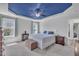 Bright main bedroom with a blue accent ceiling, ceiling fan, and carpet flooring at 85 Willard Wood Run, Benson, NC 27504