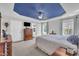 Main bedroom showcasing a tray ceiling, ceiling fan, and ensuite bathroom at 85 Willard Wood Run, Benson, NC 27504