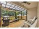 Relaxing screened-in patio features a ceiling fan, grill, and comfortable seating area at 85 Willard Wood Run, Benson, NC 27504