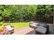 Cozy back yard featuring comfortable seating on the patio, surrounded by lush greenery and a privacy fence at 916 Woodside Park Ln, Durham, NC 27704