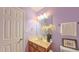 Comfortable bathroom with a modern mirror, vanity, and lavender walls at 916 Woodside Park Ln, Durham, NC 27704