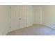 Bedroom with neutral carpet, double closets, and white walls for a clean, minimalist feel at 916 Woodside Park Ln, Durham, NC 27704