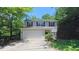 Inviting two-story home featuring a large front yard and attached garage at 916 Woodside Park Ln, Durham, NC 27704