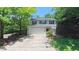 Two-story home with a two-car garage, manicured lawn, and a tree-lined street at 916 Woodside Park Ln, Durham, NC 27704