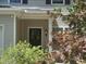 Inviting front entrance with a black door, wreath, plants, and visible house number at 916 Woodside Park Ln, Durham, NC 27704