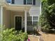 Welcoming front entrance with black door, wreath, and plants, offering a charming curb appeal at 916 Woodside Park Ln, Durham, NC 27704