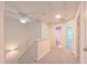 Hallway landing showcasing access to bathroom and bedrooms with neutral carpet at 916 Woodside Park Ln, Durham, NC 27704