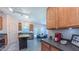 Well-lit eat-in kitchen featuring stainless steel appliances, island and view into dining area, perfect for entertaining at 916 Woodside Park Ln, Durham, NC 27704