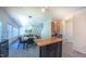 Bright eat-in kitchen with modern island, stainless steel appliances, and views into living and dining areas at 916 Woodside Park Ln, Durham, NC 27704
