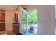 Kitchen with stainless appliances overlooks patio and lush backyard through open door at 916 Woodside Park Ln, Durham, NC 27704