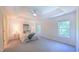 Spacious main bedroom offering natural light, a ceiling fan, and neutral carpet at 916 Woodside Park Ln, Durham, NC 27704