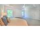 Open primary bedroom boasting a ceiling fan, natural light, and neutral carpet at 916 Woodside Park Ln, Durham, NC 27704