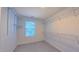 Spacious walk-in closet with ample shelving and a bright window at 916 Woodside Park Ln, Durham, NC 27704