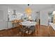 Open dining area featuring a round table, modern lighting, and a view into the kitchen at 926 Wimbleton Dr, Raleigh, NC 27609
