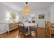 Elegant dining room with a round table, unique chandelier, and access to living spaces at 926 Wimbleton Dr, Raleigh, NC 27609