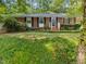 Classic brick home featuring lush landscaping and a welcoming entrance at 926 Wimbleton Dr, Raleigh, NC 27609