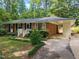 Traditional brick home with attached carport and beautifully landscaped front yard at 926 Wimbleton Dr, Raleigh, NC 27609
