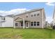 Expansive backyard with lush green grass and a covered patio, perfect for outdoor entertaining at 94 Black Walnut Dr # 201, Garner, NC 27529