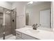 Modern bathroom with a white quartz countertop, matte black faucet, and glass enclosed shower at 94 Black Walnut Dr # 201, Garner, NC 27529