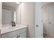 This bathroom features a single vanity, a mirror, and a neutral color palette at 94 Black Walnut Dr # 201, Garner, NC 27529