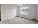 This bedroom offers neutral decor, carpet, a window with a view, and a closet at 94 Black Walnut Dr # 201, Garner, NC 27529