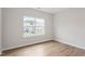 Bright bedroom with large window and hardwood floors offering a peaceful retreat at 94 Black Walnut Dr # 201, Garner, NC 27529