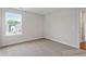 This bedroom offers neutral decor, carpet, and a window to let in the natural light at 94 Black Walnut Dr # 201, Garner, NC 27529