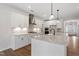 Well-appointed kitchen featuring white cabinets, granite countertops, and a spacious island at 94 Black Walnut Dr # 201, Garner, NC 27529