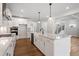 Gourmet kitchen featuring white cabinets, granite countertops, and stainless steel appliances at 94 Black Walnut Dr # 201, Garner, NC 27529