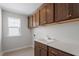 Laundry room with ample cabinets and a utility sink at 94 Black Walnut Dr # 201, Garner, NC 27529