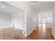 Bright living room featuring hardwood floors, white trim, and an open doorway at 94 Black Walnut Dr # 201, Garner, NC 27529