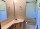 Bright bathroom featuring a single sink vanity, a large mirror, and a shower/tub combo at 94 S Waters Edge Ln, Henderson, NC 27537