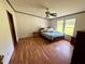 A bright bedroom with a ceiling fan and hardwood flooring is ready for comfortable living at 94 S Waters Edge Ln, Henderson, NC 27537