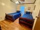 Cozy bedroom featuring two twin beds with matching blue comforters and wood-look floors at 94 S Waters Edge Ln, Henderson, NC 27537