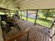 Enjoy outdoor living on this screened porch that overlooks a green lawn at 94 S Waters Edge Ln, Henderson, NC 27537