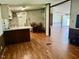 Open dining area features a chandelier and wood floors that flow into the kitchen and living spaces at 94 S Waters Edge Ln, Henderson, NC 27537