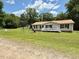 Charming single-story home with a front porch, a playground, and a spacious front yard at 94 S Waters Edge Ln, Henderson, NC 27537
