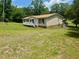 Cozy single-story home with a inviting porch, surrounded by a lush green landscape at 94 S Waters Edge Ln, Henderson, NC 27537