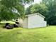 Exterior shot showing large detached garage with covered parking on a grassy lawn at 94 S Waters Edge Ln, Henderson, NC 27537