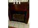 A detailed close-up of a fireplace with a glass-enclosed firebox and decorative features at 94 S Waters Edge Ln, Henderson, NC 27537