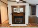 A charming fireplace with wooden mantel and decorative accents at 94 S Waters Edge Ln, Henderson, NC 27537
