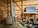 Interior of a garage with wood framing and an old wood burning stove at 94 S Waters Edge Ln, Henderson, NC 27537