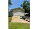 Large detached garage with a boat trailer parked out front on a concrete pad at 94 S Waters Edge Ln, Henderson, NC 27537