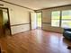 Bright living room with wood flooring and large windows, offering plenty of natural light at 94 S Waters Edge Ln, Henderson, NC 27537