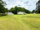 Property shot shows a house, yard, and additional buildings at 94 S Waters Edge Ln, Henderson, NC 27537