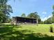 Home featuring a screened-in porch in backyard, offering a relaxing space to enjoy nature at 94 S Waters Edge Ln, Henderson, NC 27537