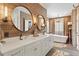 This bathroom features a double vanity, wood accent wall, soaking tub and modern finishes at 9940 Koupela Dr, Raleigh, NC 27614