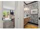 Charming primary bathroom featuring wood cabinets, white marble countertop, and bold wallpaper at 9940 Koupela Dr, Raleigh, NC 27614