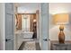 This bathroom features a soaking tub, stylish vanity, a decorative rug, and modern fixtures at 9940 Koupela Dr, Raleigh, NC 27614